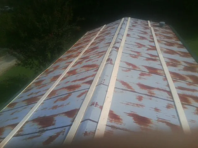 Rusted metal roof panels with new wood purlins before replacement — Storm Damage Roof Repair in Kittery by Roofing Brothers