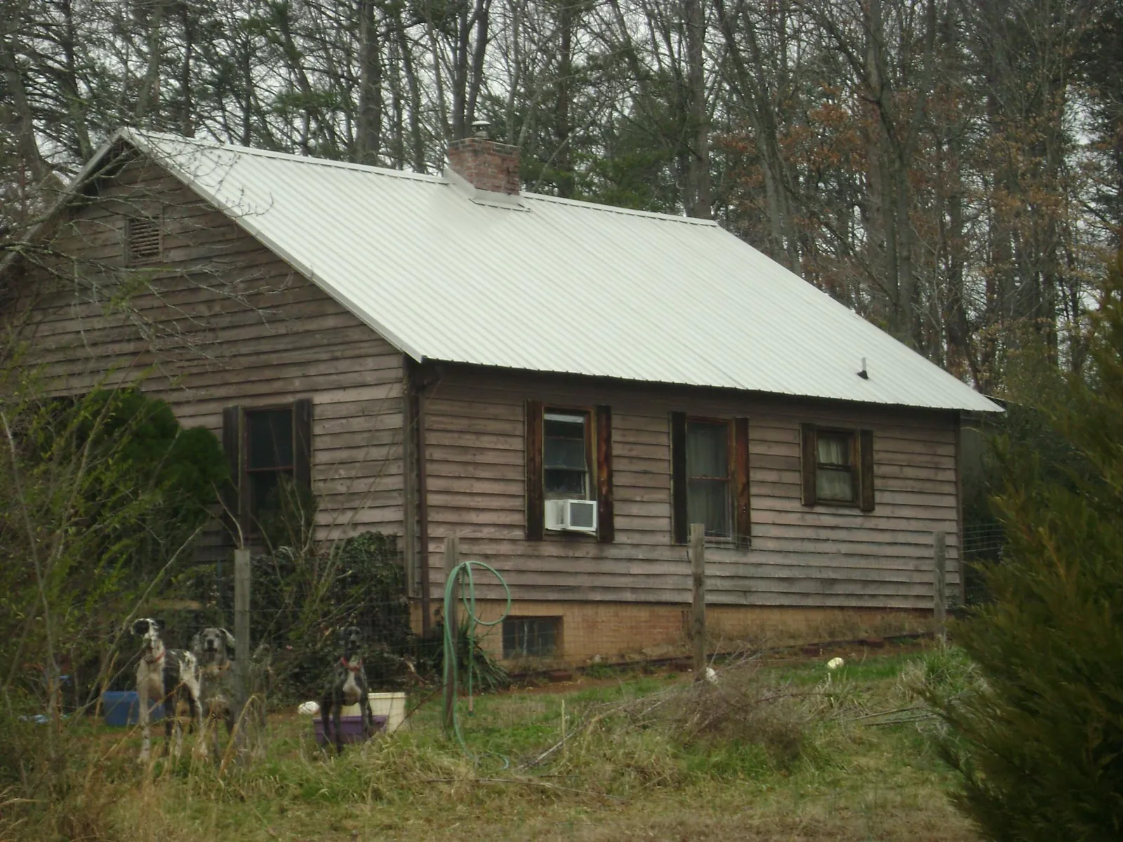 White metal roof on an old wood sided farmhouse, from a Metal Roof Installation job in Kittery